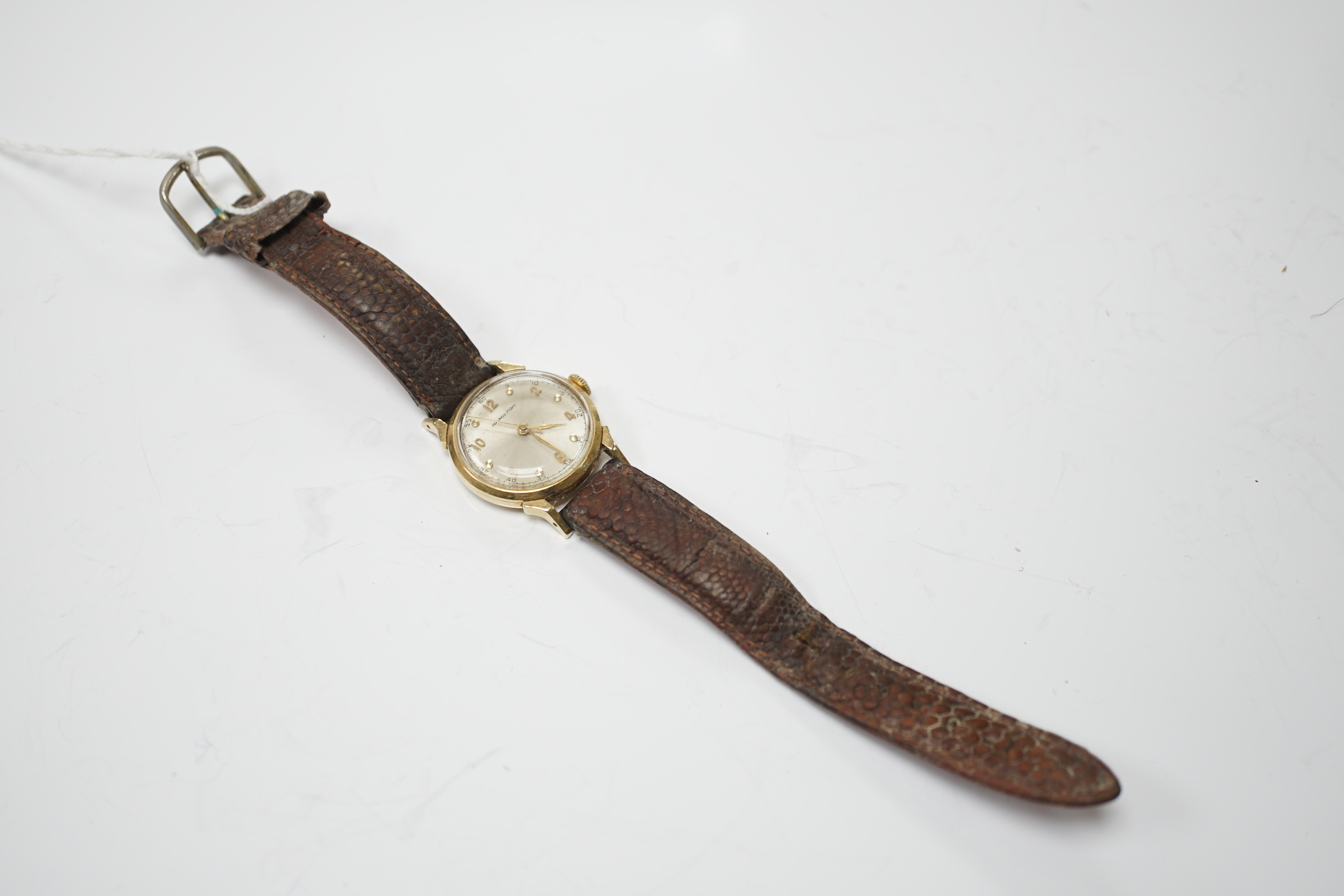 A gentleman's 14k Hamilton manual wind wrist watch, with Arabic dial, on associated leather strap.